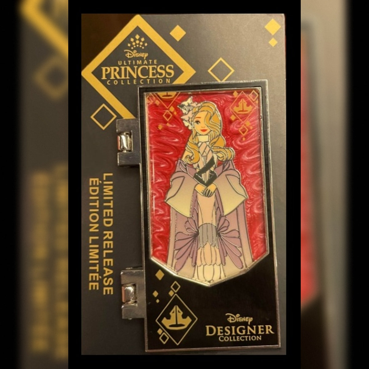 Disney Princess Collection limited edition enamel pin in its original black display packaging, featuring Briar Rose with a red and gold patterned background.