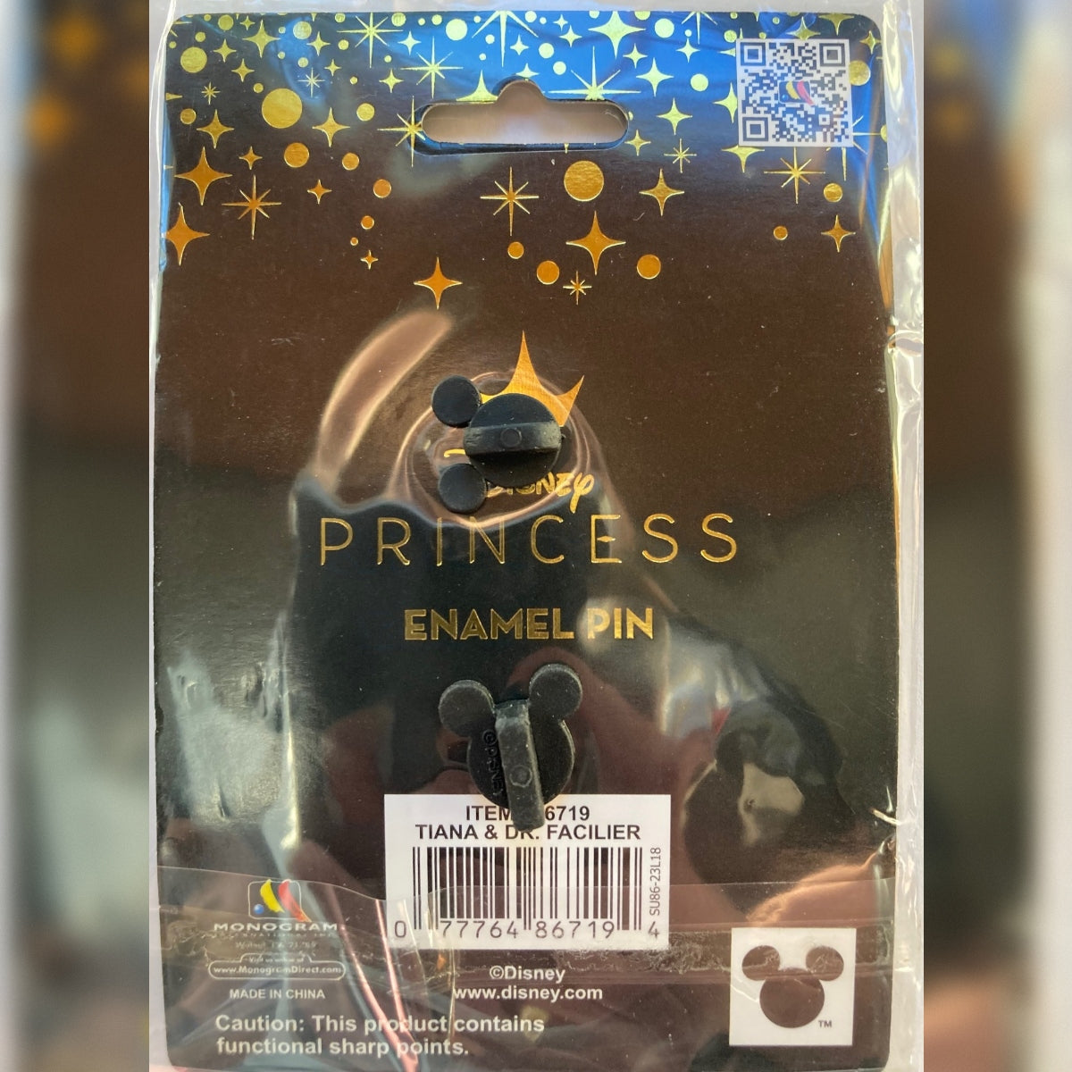 Disney Princess Enamel Pin in its original retail packaging, featuring a Tiana and Dr. Facilier pin with Mickey-shaped ear rubber clutches, a gold crown, and a starry header card.