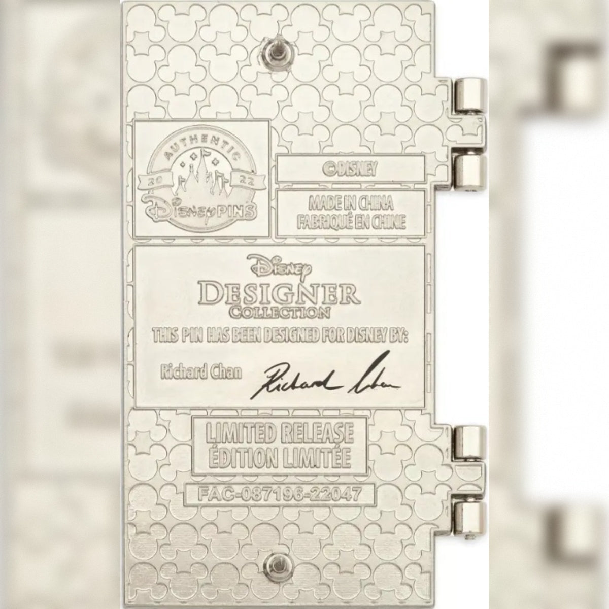 A close-up of the back of the Briar Rose a silver-toned Disney Designer Collection pin featuring embossed Disney castle and Mickey-style pattern details, with engraved text including 'Authentic Disney' 'Richard Chan' and 'Made in China Fabrique en Chine.'