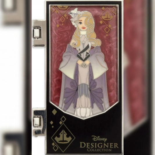 A Disney Designer Collection enamel pin of Disney's Briar Rose, displayed on its black and silver Metal Pin. The pin features Briar Rose in her purple and white gown with gold accents, set against a dark red patterned background