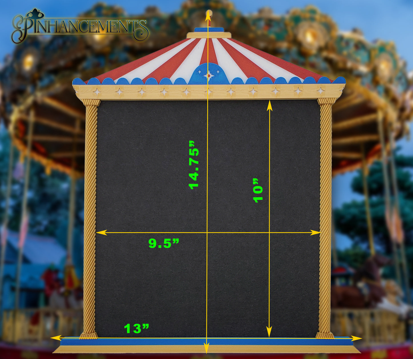 A straight-on view of a Pinhancements 3D-printed, carousel-themed pinboard. The frame features a red and white striped canopy, blue trim with star details, and twisted gold pillars bordering a large, blank black felt center for displaying enamel pins. The dimensions of the pinboard are superimposed on the picture.
