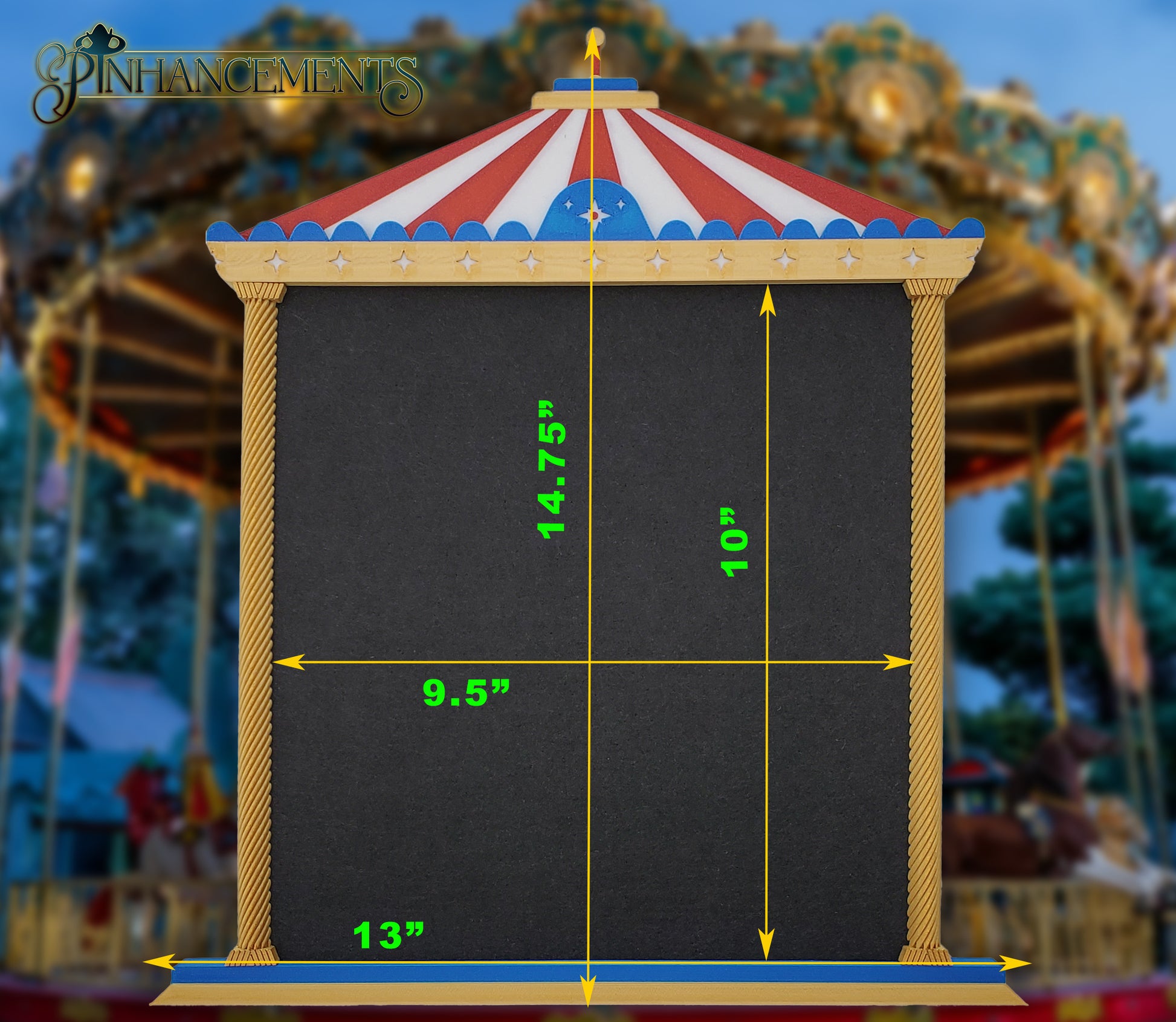 A straight-on view of a Pinhancements 3D-printed, carousel-themed pinboard. The frame features a red and white striped canopy, blue trim with star details, and twisted gold pillars bordering a large, blank black felt center for displaying enamel pins. The dimensions of the pinboard are superimposed on the picture.