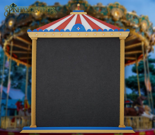 A straight-on view of a Pinhancements 3D-printed, carousel-themed pinboard. The frame features a red and white striped canopy, blue trim with star details, and twisted gold pillars bordering a large, blank black felt center for displaying enamel pins.
