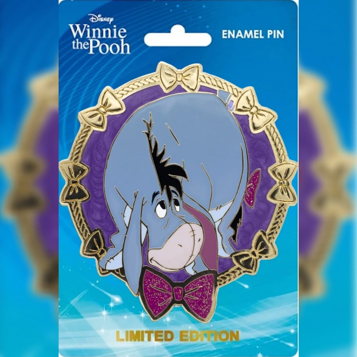 Eeyore PALM jumbo enamel pin with a purple background and gold bow border on a blue Disney Winnie the Pooh backing card.
