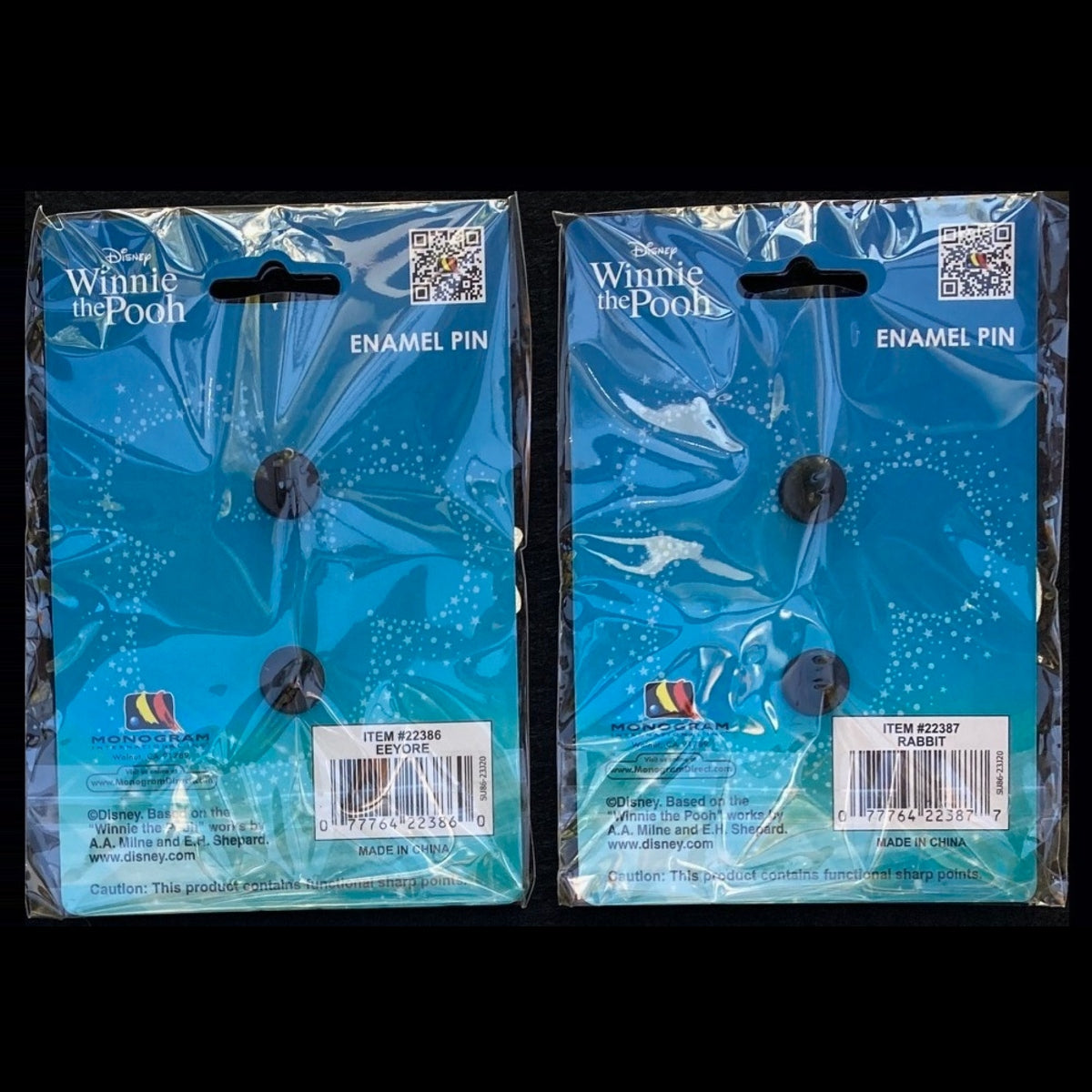 Backs of packaged Eeyore and Rabbit pins showing blue Disney Winnie the Pooh cards, rubber clutches and item labels.