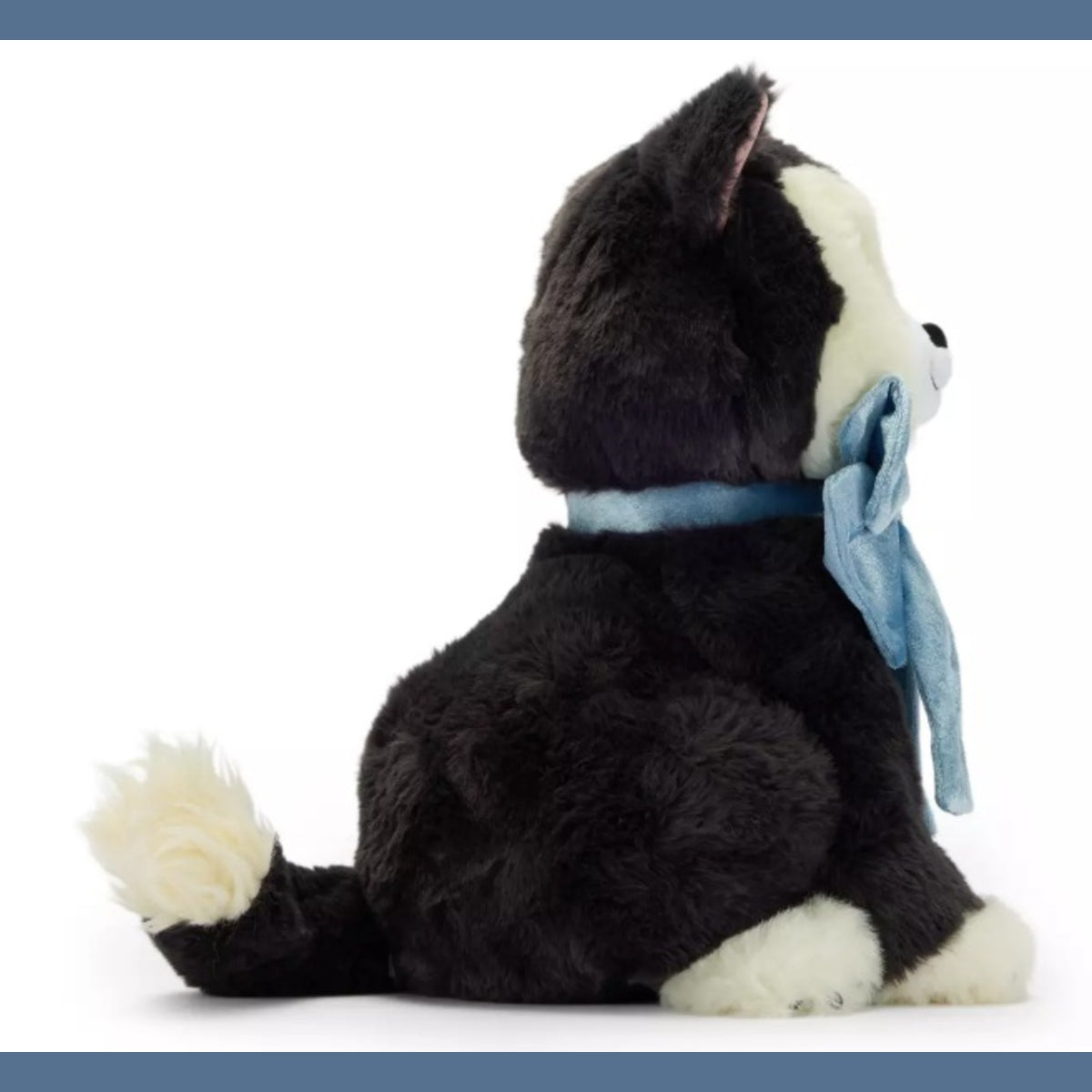 Disney Figaro plush shown from the side, featuring black and white fur with a light blue ribbon tied around its neck, set against a plain white background.