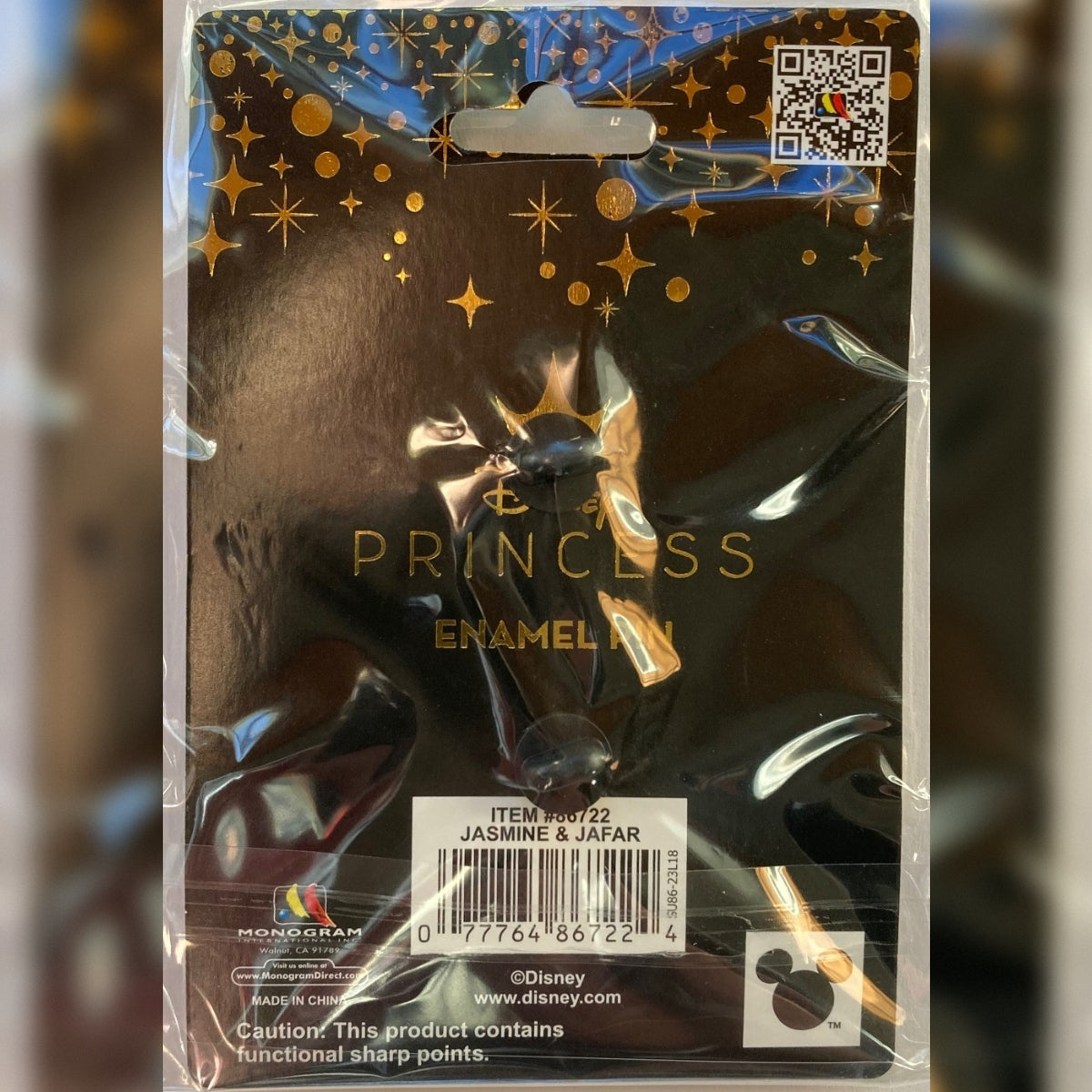 Reverse view of the sealed Disney Princess backing card for the Jasmine and Jafar storybook enamel pin, featuring Item 86722 barcode and Monogram International branding