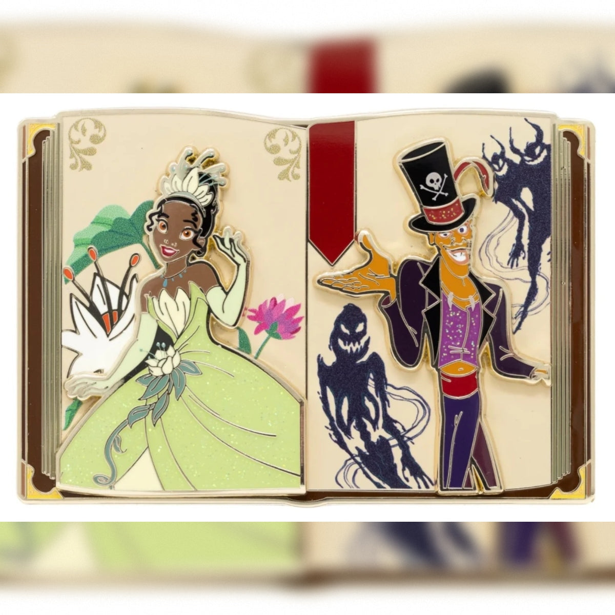 A Tiana storybook enamel pin featuring Disney characters: Tiana in a light green gown on the left page and Dr. Facilier in a top hat with skull-and-crossbones motif on the right page, shown against a softly blurred beige background.